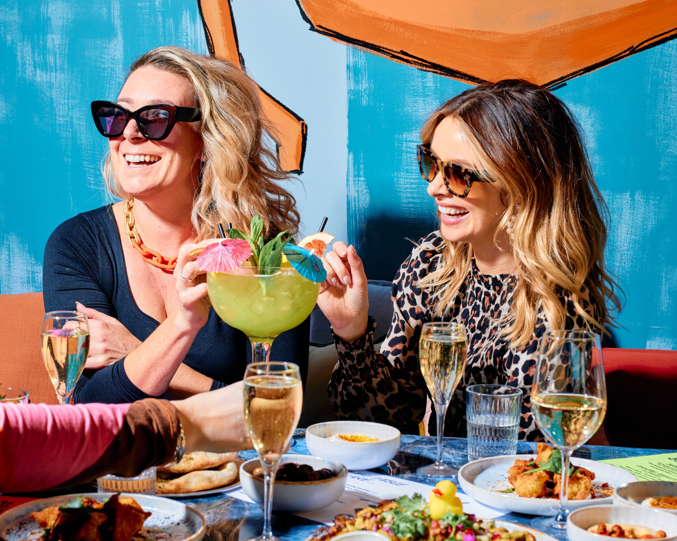 Two women enjoying drinks at a table